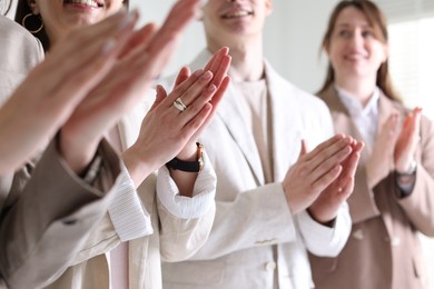 People applauding during meeting indoors, closeup view