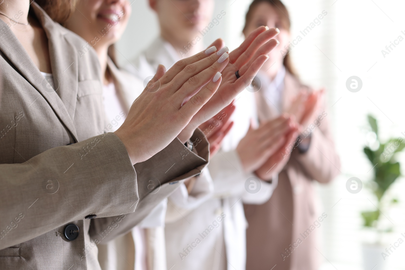 Photo of People applauding during meeting indoors, closeup view