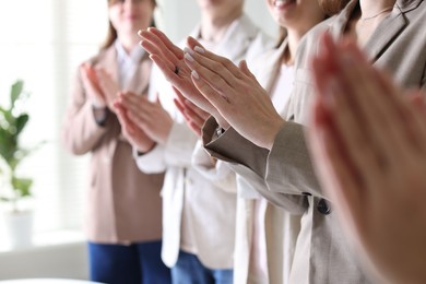 People applauding during meeting indoors, closeup view