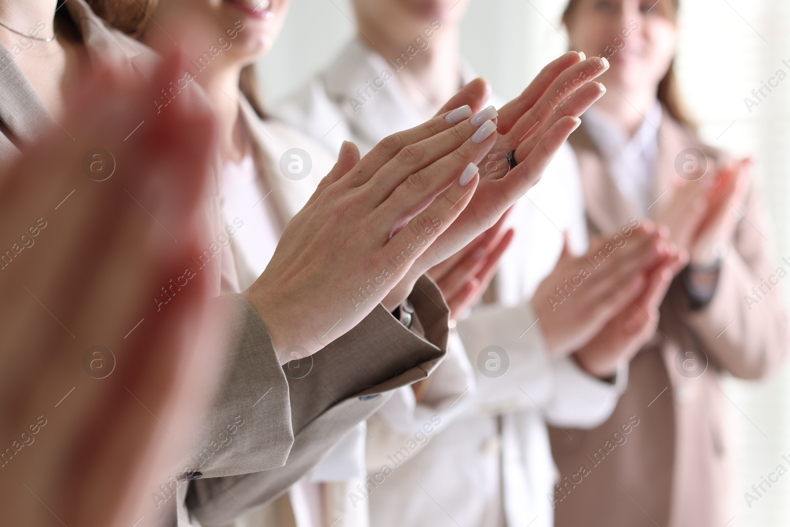 Photo of People applauding during meeting indoors, closeup view