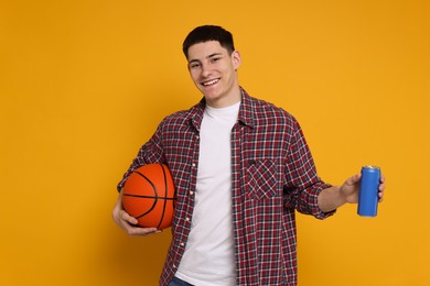 Photo of Student with basketball ball and can of drink on orange background