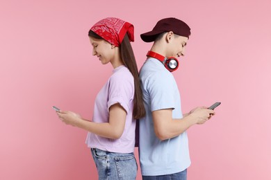 Photo of Portrait of students with smartphones on pink background