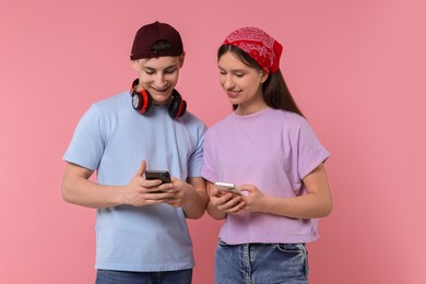 Photo of Portrait of students with smartphones on pink background