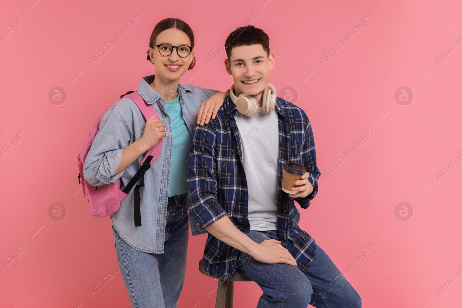 Photo of Portrait of stylish students on pink background