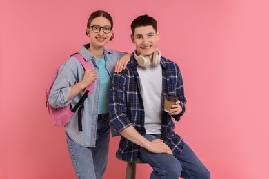 Portrait of stylish students on pink background