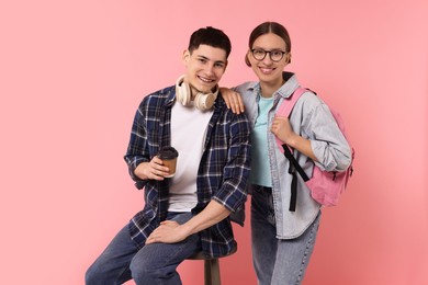 Portrait of stylish students on pink background