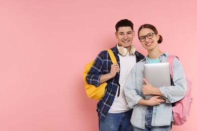 Students with backpacks and laptop on pink background, space for text