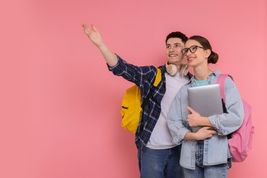 Photo of Students with backpacks and laptop on pink background, space for text