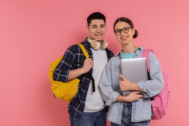 Photo of Students with backpacks and laptop on pink background, space for text