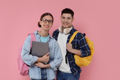 Students with backpacks and laptop on pink background