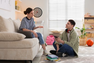 Happy students spending time together at home