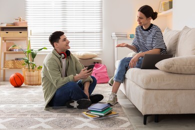 Photo of Happy students spending time together at home