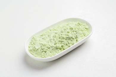 Photo of Dry wasabi powder on white textured table, closeup