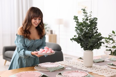 Photo of Woman setting table for dinner at home