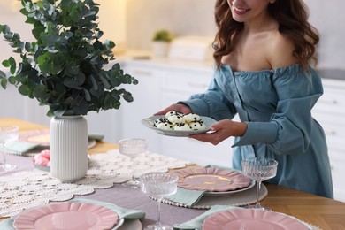 Photo of Woman setting table for dinner at home, closeup