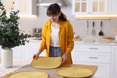 Photo of Woman setting table for dinner at home