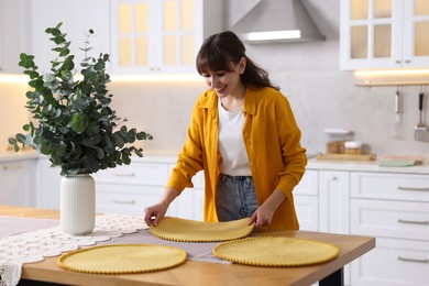 Photo of Woman setting table for dinner at home