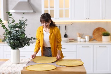 Photo of Woman setting table for dinner at home