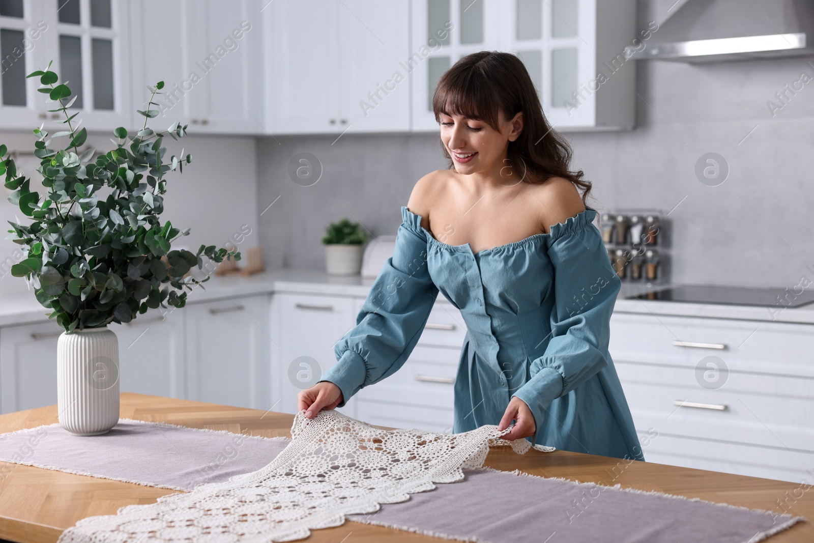 Photo of Woman setting table for dinner at home