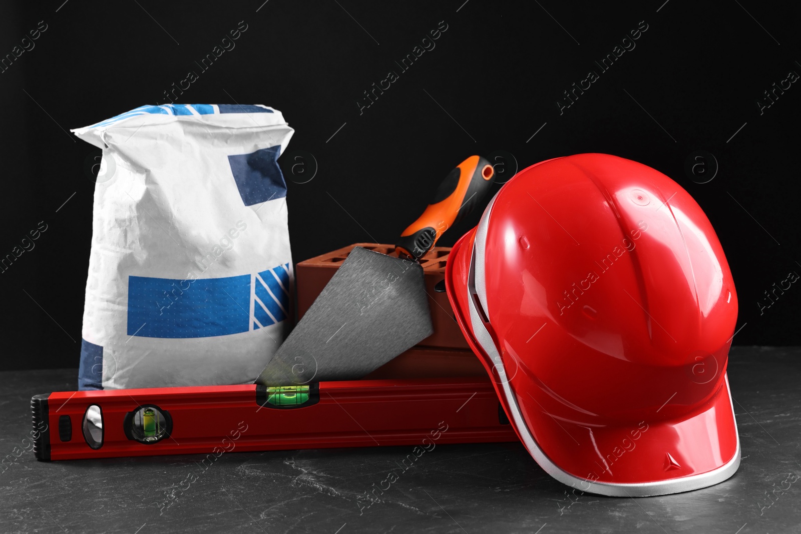 Photo of Different construction material and tools on grey table