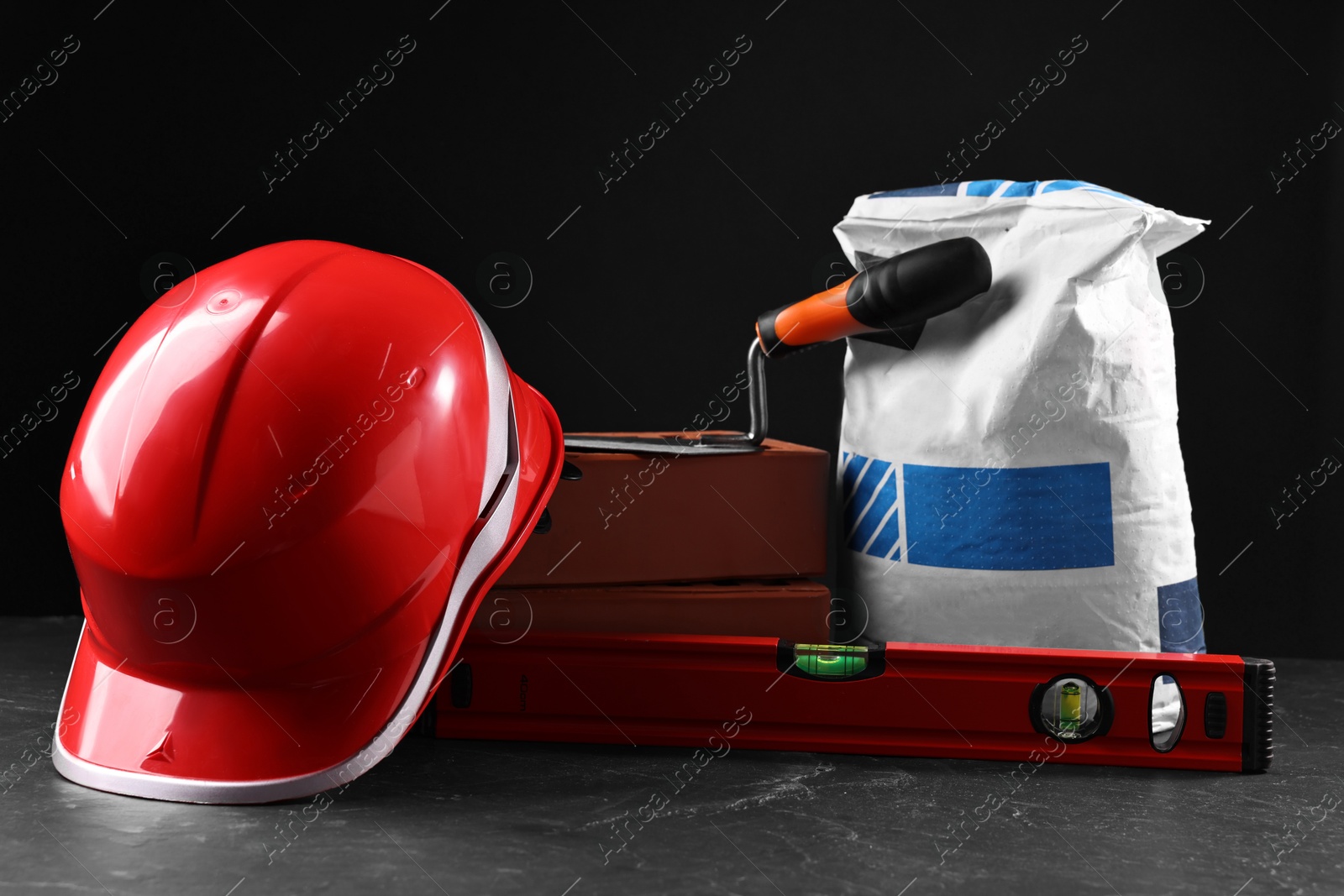 Photo of Different construction material and tools on grey table