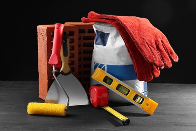 Photo of Different construction material and tools on black table