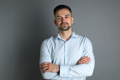 Photo of Portrait of handsome middle aged man on grey background