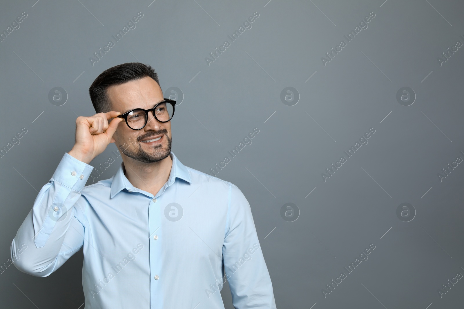 Photo of Portrait of handsome middle aged man on grey background, space for text