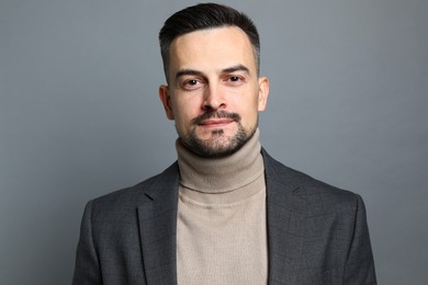 Photo of Portrait of handsome middle aged man on grey background