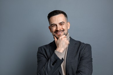 Photo of Portrait of handsome middle aged man on grey background