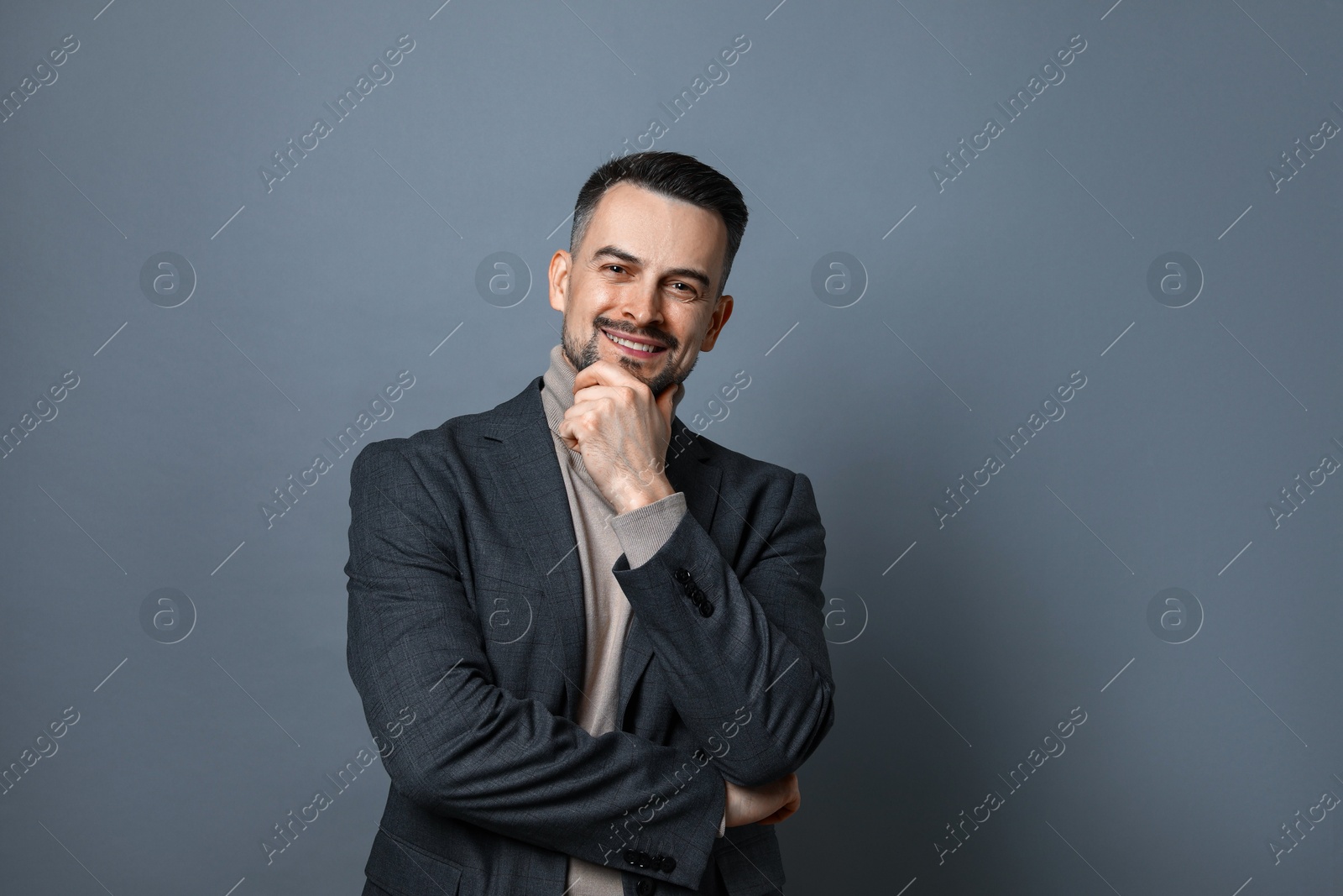 Photo of Portrait of handsome middle aged man on grey background