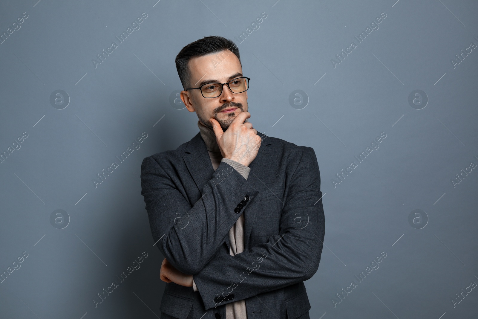 Photo of Portrait of handsome middle aged man on grey background