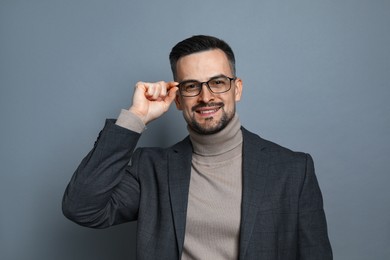 Photo of Portrait of handsome middle aged man on grey background