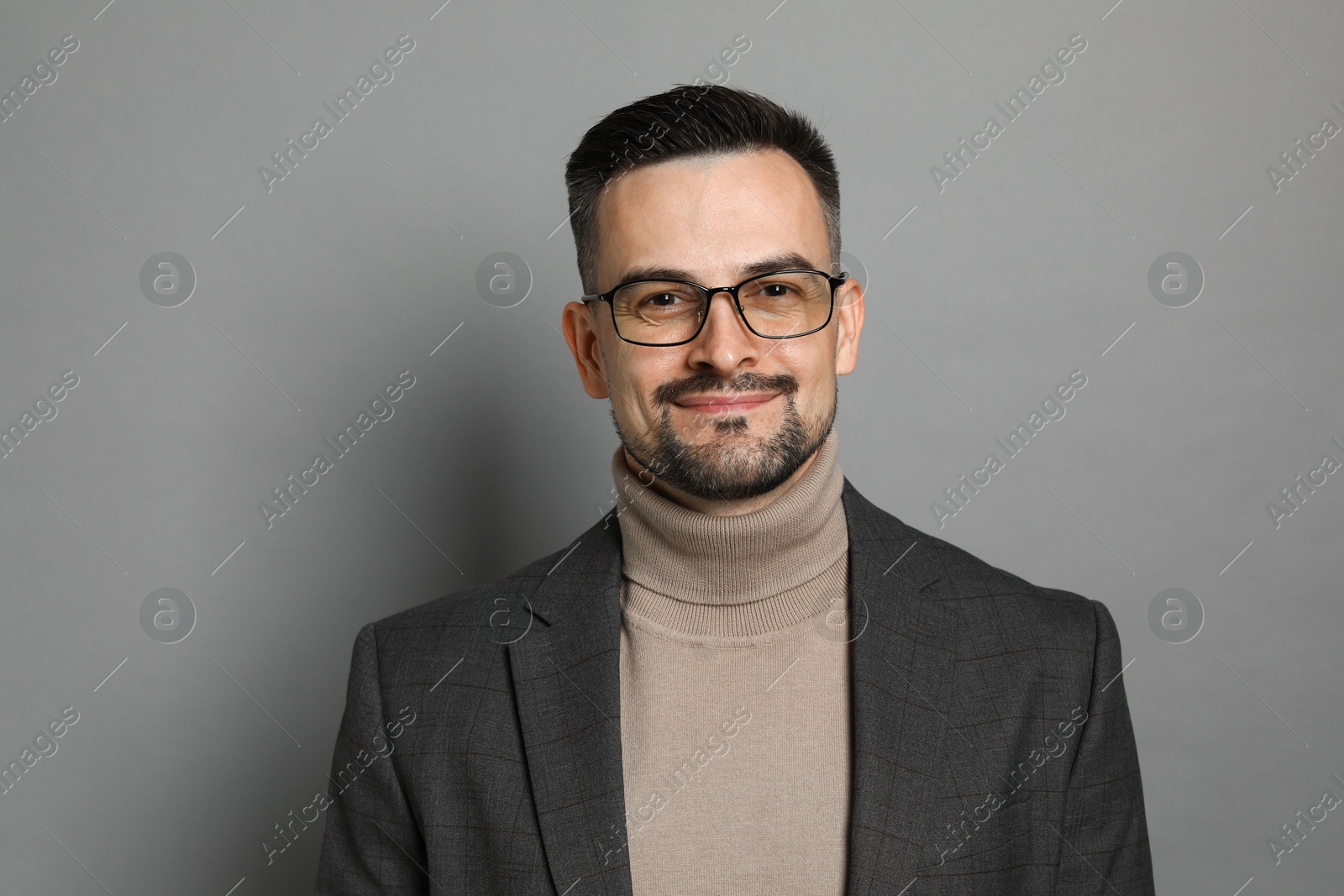 Photo of Portrait of handsome middle aged man on grey background