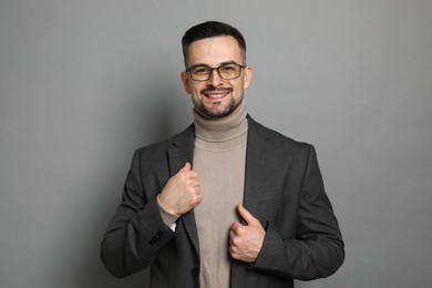 Photo of Portrait of handsome middle aged man on grey background