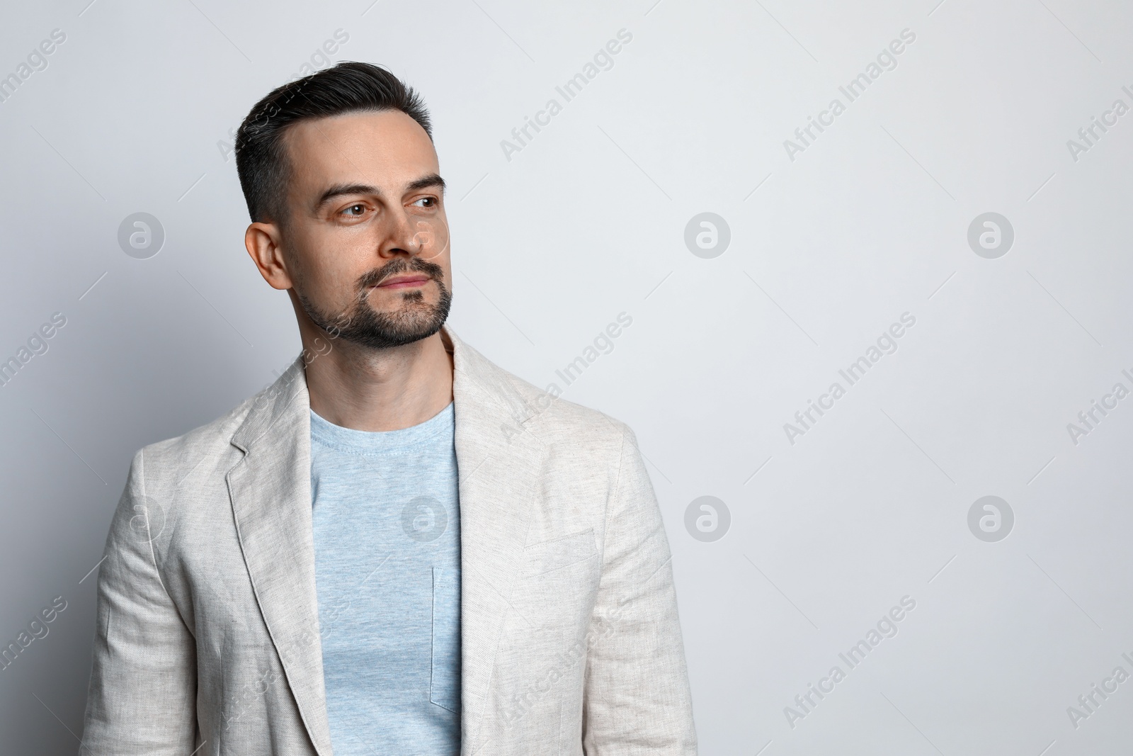 Photo of Portrait of handsome middle aged man on light background, space for text