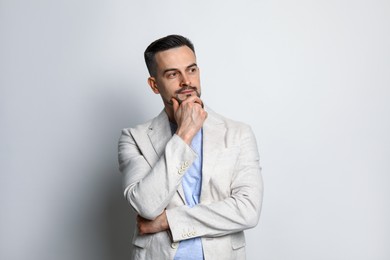 Photo of Portrait of handsome middle aged man on light background