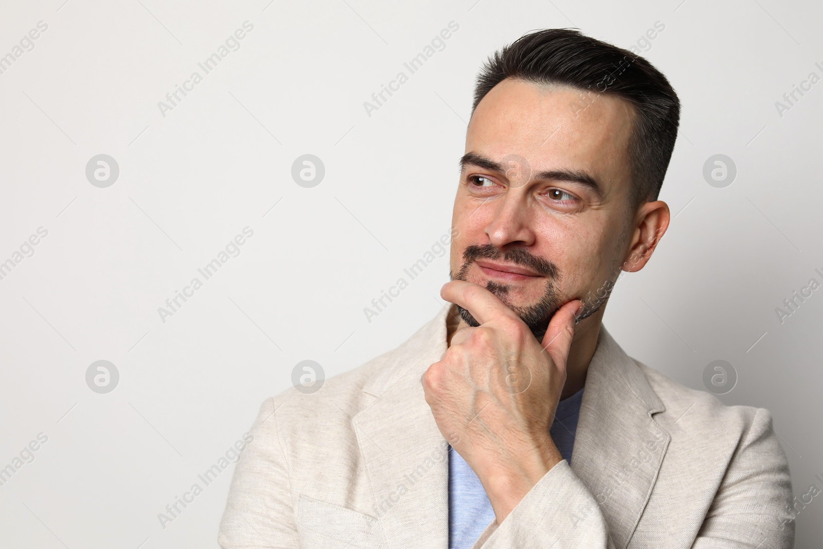 Photo of Portrait of handsome middle aged man on light background, space for text