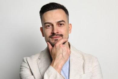 Portrait of handsome middle aged man on light background