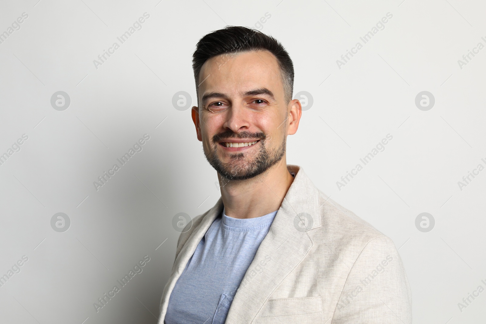 Photo of Portrait of handsome middle aged man on light background