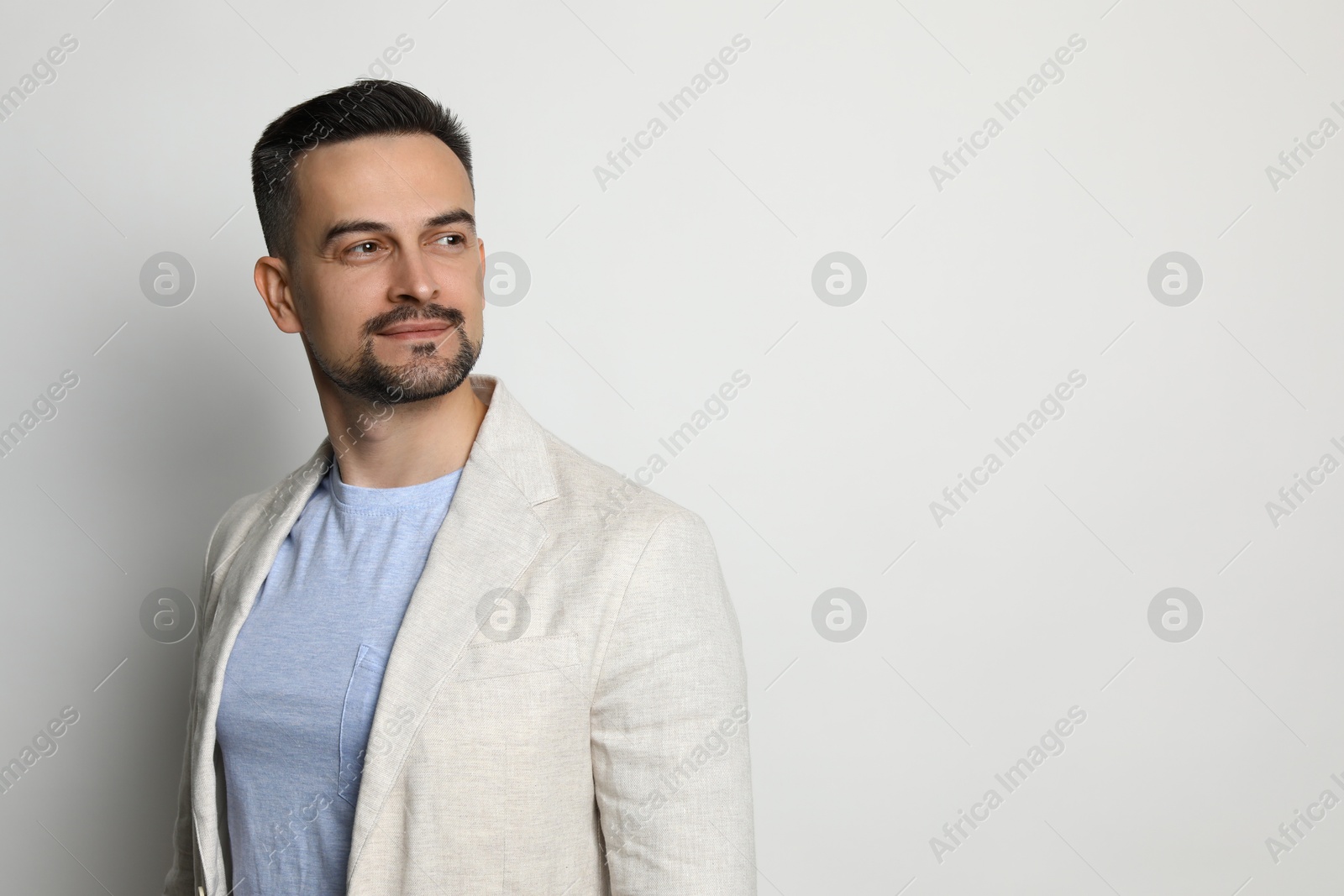 Photo of Portrait of handsome middle aged man on light background, space for text