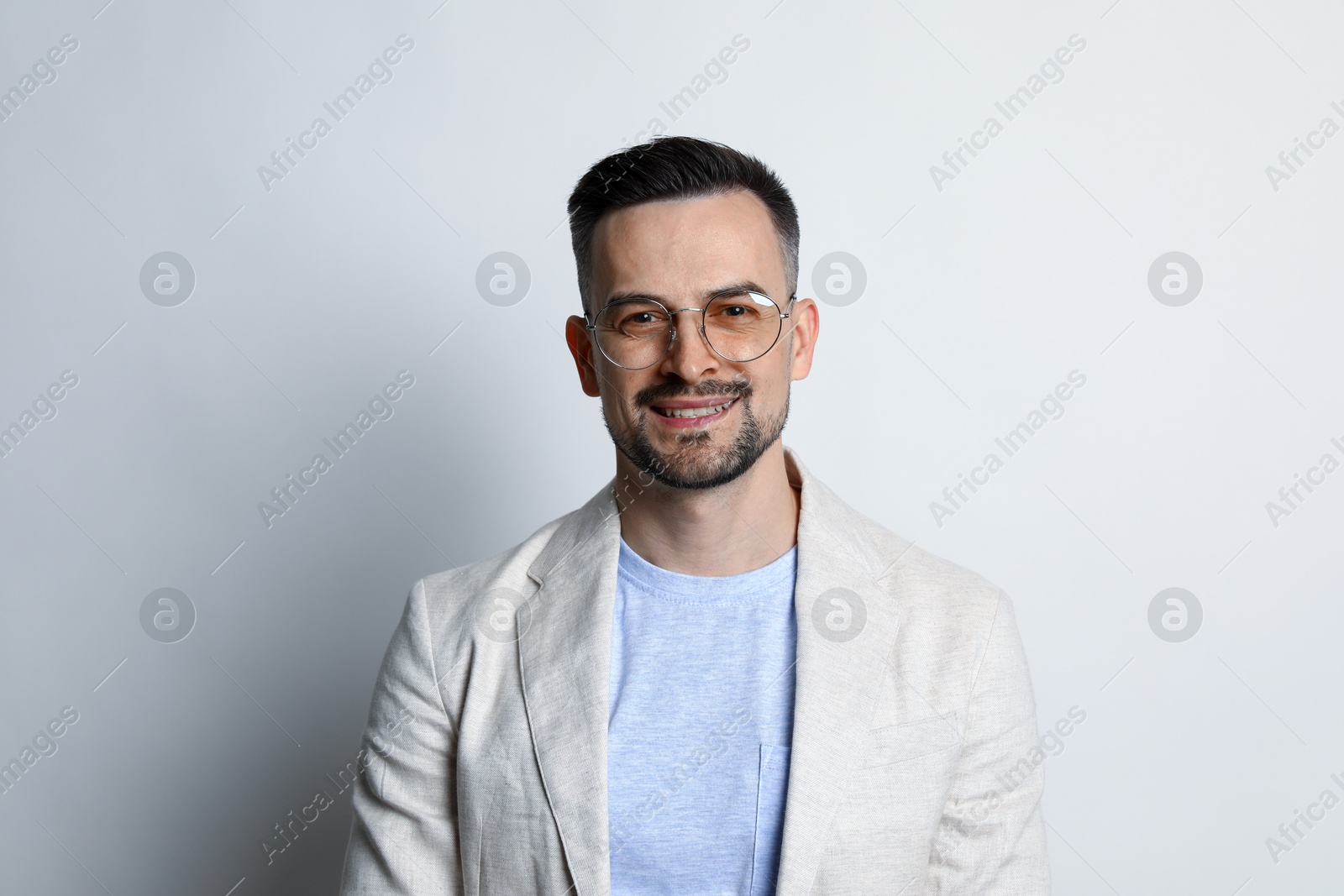 Photo of Portrait of handsome middle aged man on light background