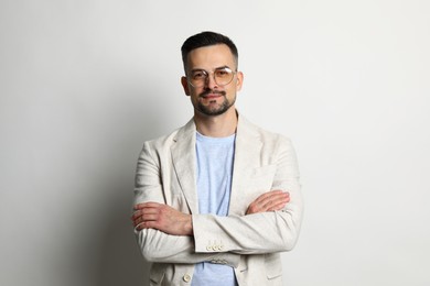 Portrait of handsome middle aged man on light background