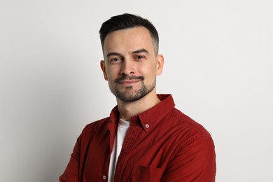 Photo of Portrait of handsome middle aged man on light background