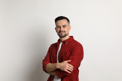 Portrait of handsome middle aged man on light background