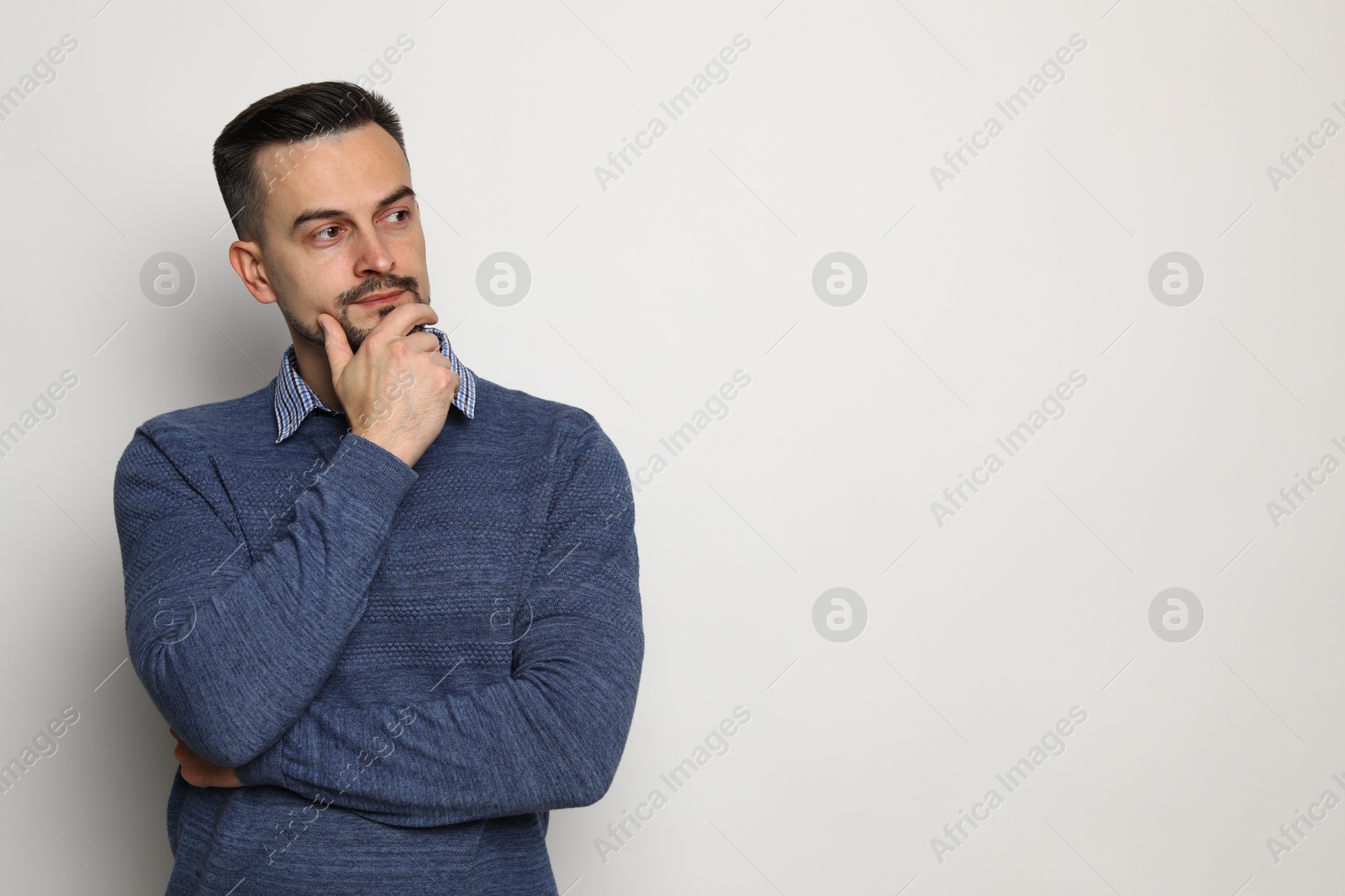 Photo of Portrait of handsome middle aged man on light background, space for text