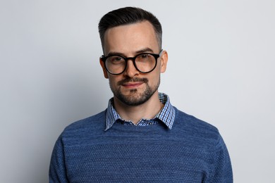 Photo of Portrait of handsome middle aged man on light background