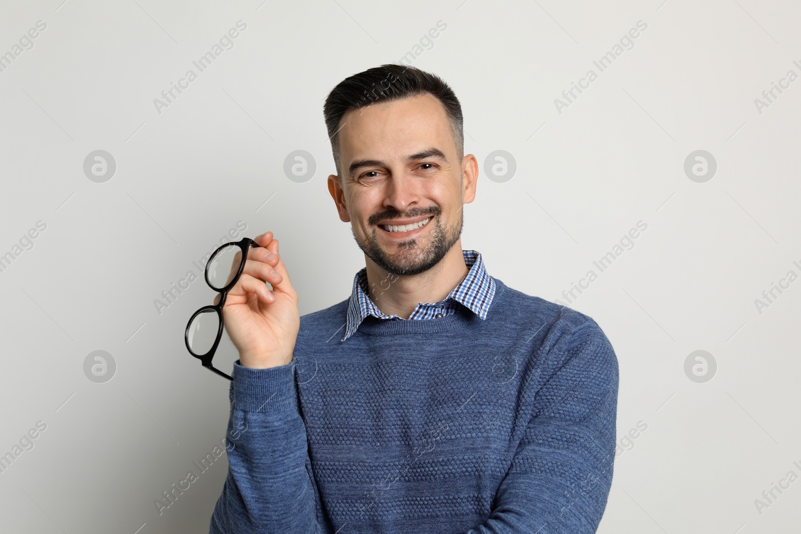 Photo of Portrait of handsome middle aged man on light background