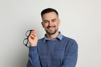 Photo of Portrait of handsome middle aged man on light background