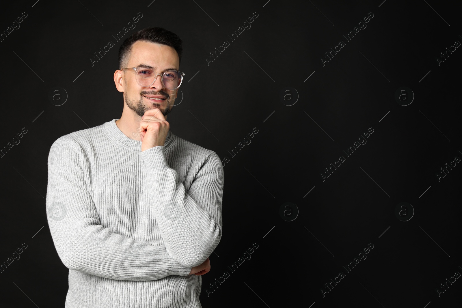 Photo of Portrait of handsome middle aged man on black background, space for text